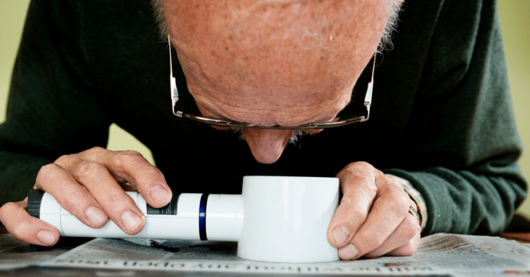 Man using a reading device for low vision issues
