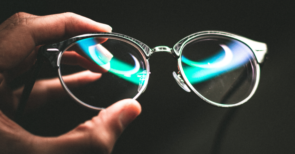 Hand holding eyeglasses