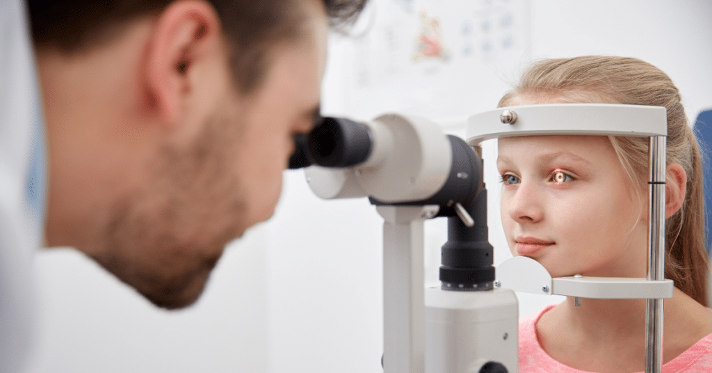 Eye doctor examining pediatric patient
