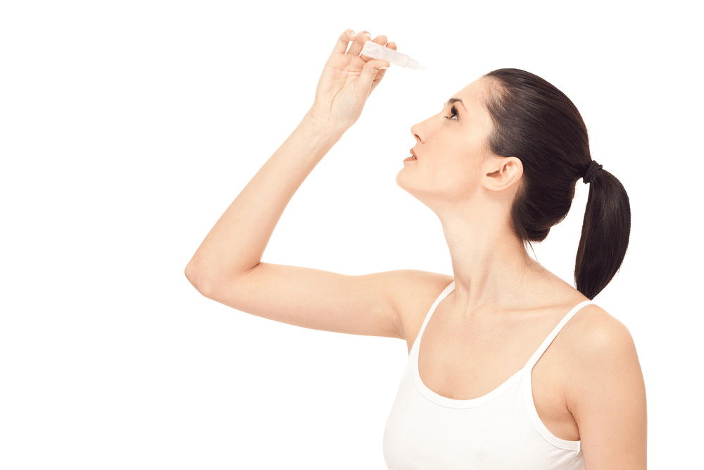 Woman using eye drops for dry eye condition