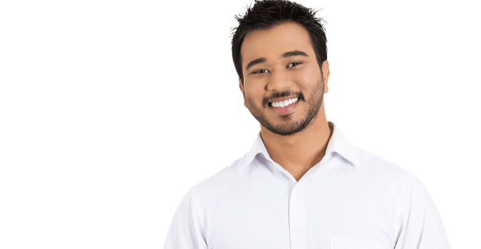 Happy man standing against a white background