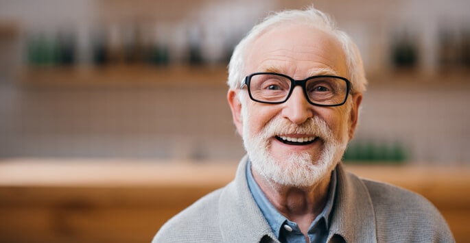 Happy older glaucoma age man wearing glasses